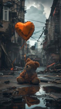 a teddy bear sitting on the ground with a heart shaped balloon attached to it's head