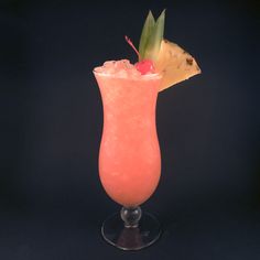 a pink drink with a pineapple garnish on top