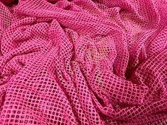 a close up view of a pink fabric that has been woven into the shape of a heart