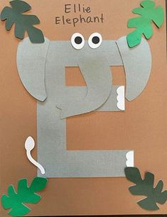 an elephant made out of paper with leaves on it's head and the letter e