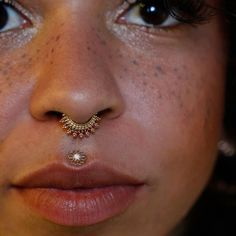 a woman with a nose piercing on her nose