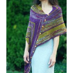 a woman wearing a purple and yellow knitted shawl