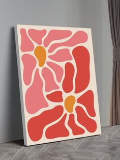 a pink and yellow abstract painting on a wall