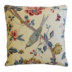 a decorative pillow with birds and flowers on it