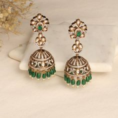 Description The Esther CZ Jhumka Earrings combine the classic and contemporary aesthetics seamlessly. They feature a distinctive design that draws inspiration from the Victorian era, embellished with sparkling CZ stones to enhance their allure. For an optimal effect, wear these exquisite earrings with your preferred Tarinika Jewelry pieces. Details & Specifications: Materials used: CZ Stone with Antique Gold Plating Weight - Earrings 31.35 gm Length - Earrings 7.5 cm Make it custom Want to make Victorian Jhumkas, Fusion Style Cutdana Chandbalis For Reception, Fusion Style Chandbalis With Cutdana For Reception, Fusion Style Reception Chandbalis With Cutdana, Fusion Style Stone Work Earrings For Festive Season, Elegant Green Jhumkas For Reception, Fusion Style Hand Set Danglers For Diwali, Fusion Style Hand-set Danglers For Diwali, Festive Fusion Chandelier Earrings With Stone Work