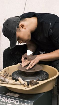 a man is working on a pottery wheel