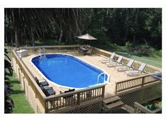 an above ground pool surrounded by deck chairs