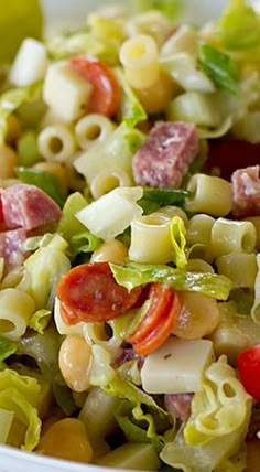 a bowl filled with pasta salad on top of a table