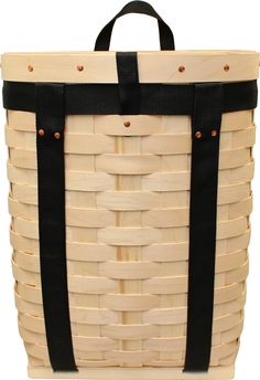 a wooden basket with black straps and handles