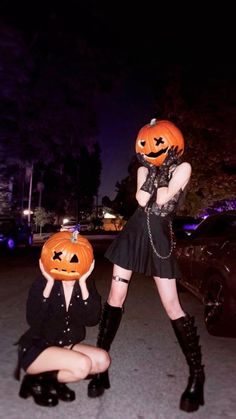 two women dressed up in halloween costumes with pumpkins on their heads