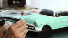 an old man is working on a model car