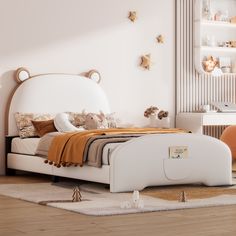 a white bed sitting on top of a wooden floor