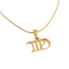 an 18k gold necklace with the word om in arabic writing on it, hanging from a