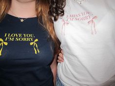 two women standing next to each other wearing t - shirts that say i love you, i'm sorry