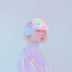 a woman with headphones on her ears standing in front of a white wall and looking off to the side