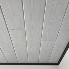 the ceiling is painted white and has wood planks