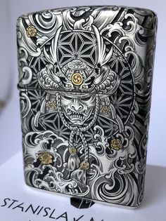 an intricately designed flask is shown on top of a white table with writing