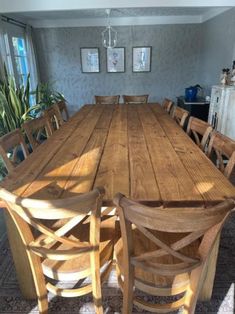 a large wooden table and chairs in a room