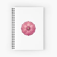 a spiral notebook with a pink flower on the front and bottom, in watercolor