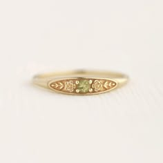 August birth ring This ring will be a very meaningful piece for those born in August . August's birthstone and birth flower are Peridot and Poppy. Greeny peridot and delicately carved poppy will shine and bloom forever. This dainty and slim signet ring is comfortable to wear all the time. This piece will be perfect gift for both to others and yourself. * Detail * Material : 14K solid gold, 18K solid gold, 925 sterling silver Color : Yellow gold, White gold or Rose gold(925 sterling silver is excluded) Stone : Natural Peridot(2.5mm) * Size * Top width : 3.7mm Shank width : 1.2mm Band depth : 2.4-0.9mm * Please check your ring size before ordering, Use this : http://www.onlineconversion.com/ring_size.htm We provide special package with some our business card, guarantee card, gift box. Please Subtle Promise Rings, August Birthstone Rings, September Birth Stone Ring, Boho Promise Ring, Engagement Rings Embedded Stone, Vintage Stone Ring, Gold Floral Ring, Simple Dainty Rings, Cute Class Rings