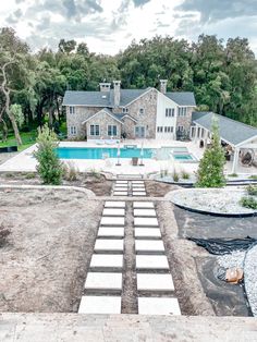 an aerial view of a house with a pool and steps leading to the front yard