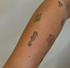 a close up of a person's arm with tattoos on it