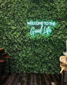 a green wall with the words welcome to the good life on it