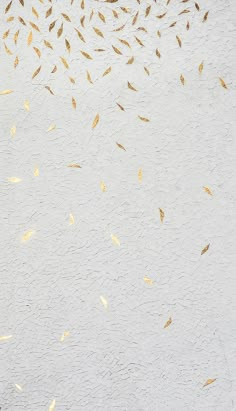 birds are flying in the air on a white wall with gold foiled leaves above them