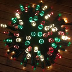 a circular arrangement of christmas lights on a wooden surface