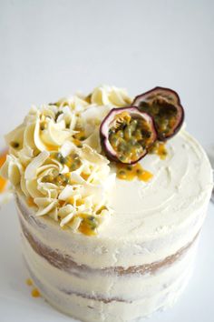 a cake with white frosting and fruit on top