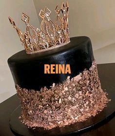 a black and gold cake with a crown on top