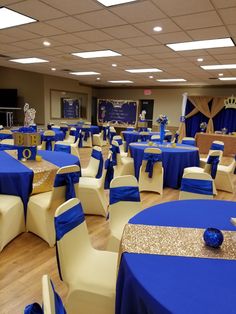 a banquet hall with blue and gold decorations