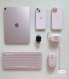 an apple keyboard, mouse, and other electronics are arranged on a white table top