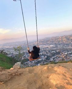 a person sitting on a swing in the air