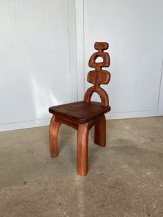 a wooden chair sitting on top of a cement floor