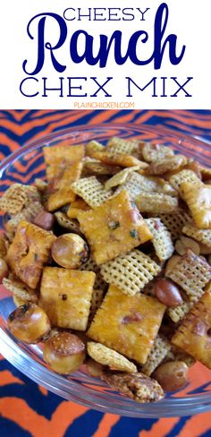 a glass bowl filled with cheetos and nuts on top of a zebra print table cloth