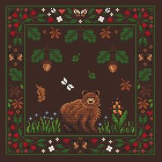 a cross stitch pattern with a bear in the grass and flowers on it's border