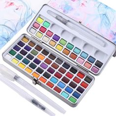 the watercolor paint set is open and ready to be filled with it's contents