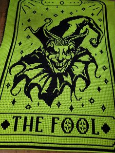 a green rug with an image of a demon on it and the words, the fool