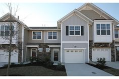 two story townhouse with garages and landscaping