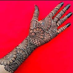 the hand is decorated with intricate designs on it