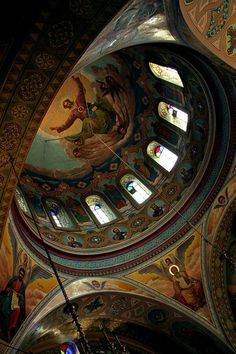 the inside of a church with many paintings on it