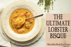 the ultimate lobster bisque is served in a white bowl