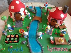 a cake that is decorated to look like a mushroom house and stream with people on it