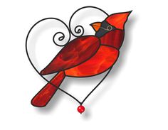 a red bird sitting on top of a heart