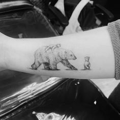 a bear and cub tattoo on the arm