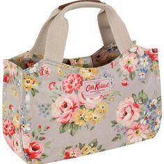 a floral lunch bag is shown with the handles open and it's handle closed