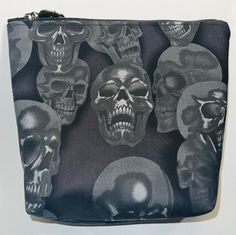 a black and white photo of skulls on a bag with zippered closure to the bottom