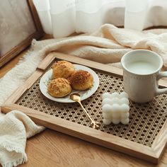 a tray with some food on it next to a cup of coffee and marshmallows