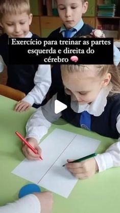 two children sitting at a table with paper and pencils